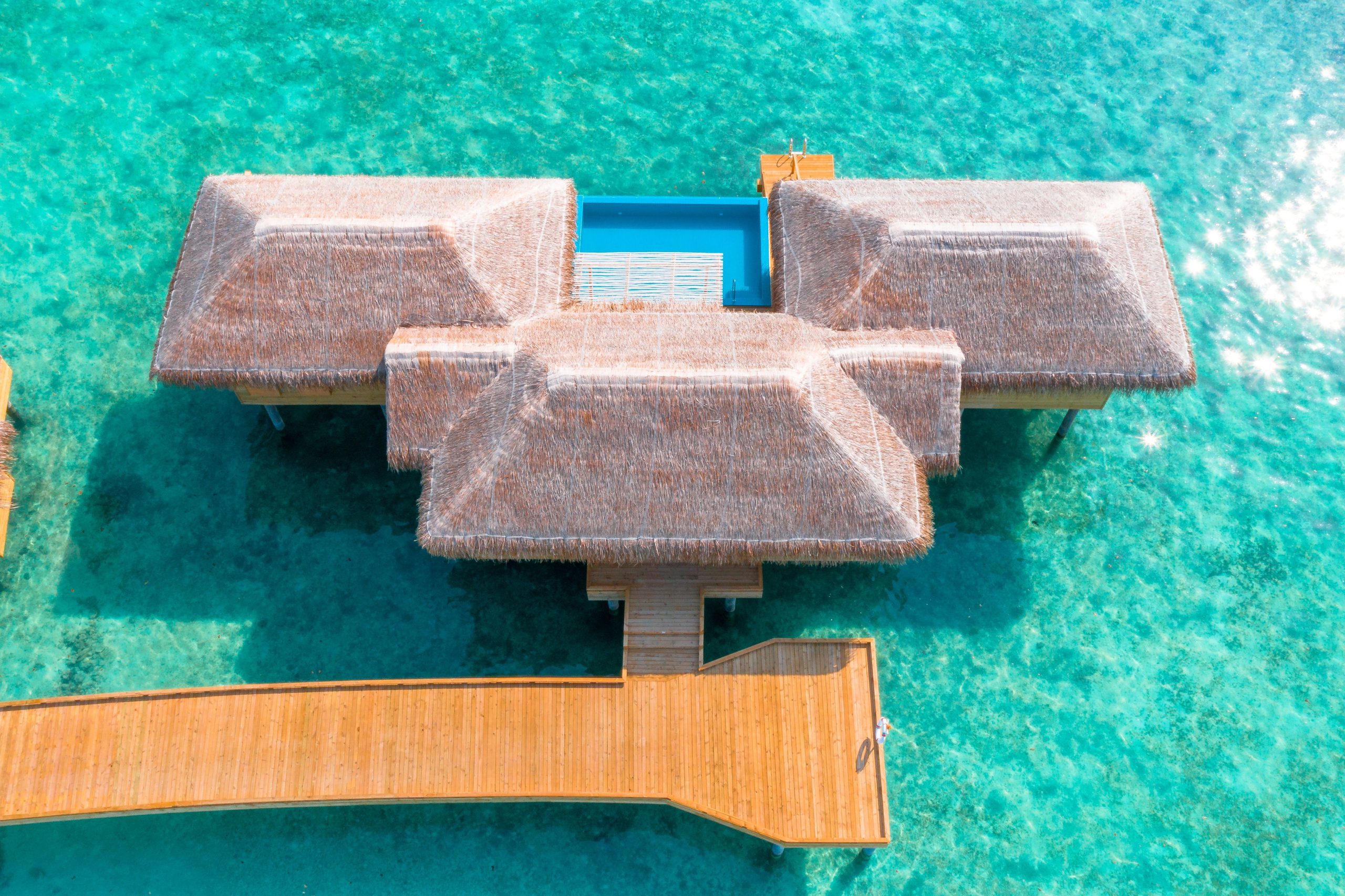 Overwater villa in a tropical turquoise Maldives lagoon
